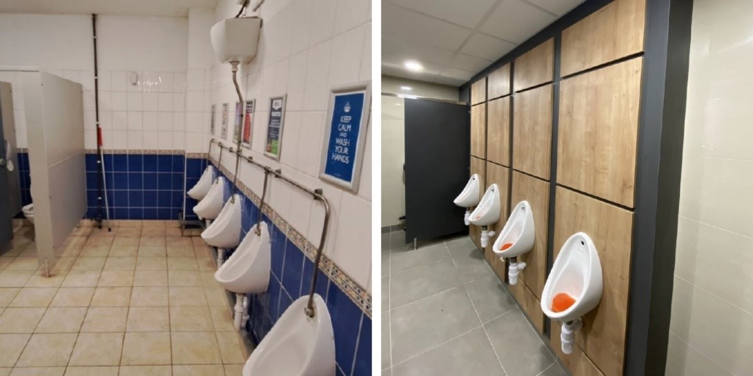 A bathroom with urinals and a blue tile floor

Description automatically generated