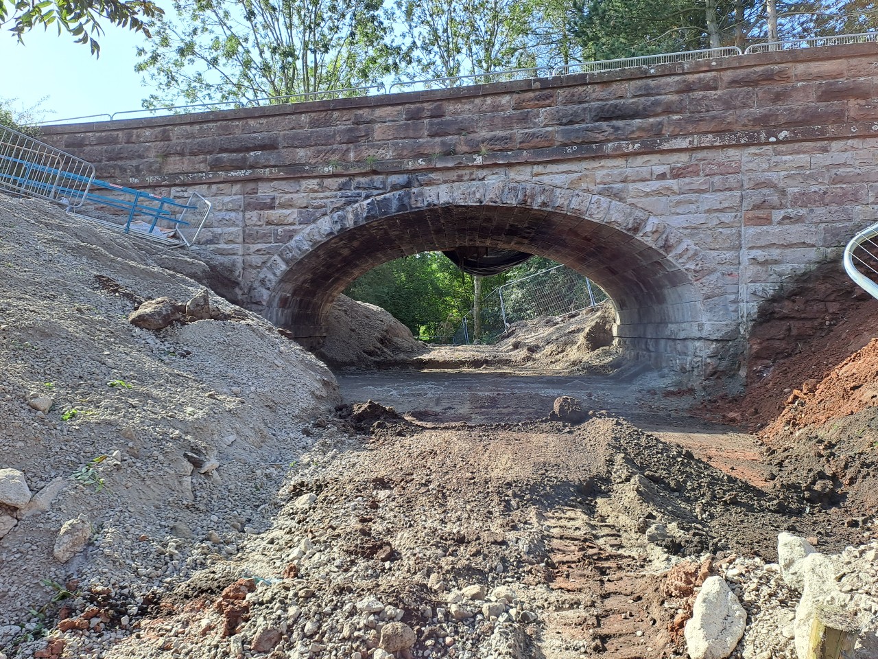 View of the arch where work has started to remove the fill material between the abutments and embankments.