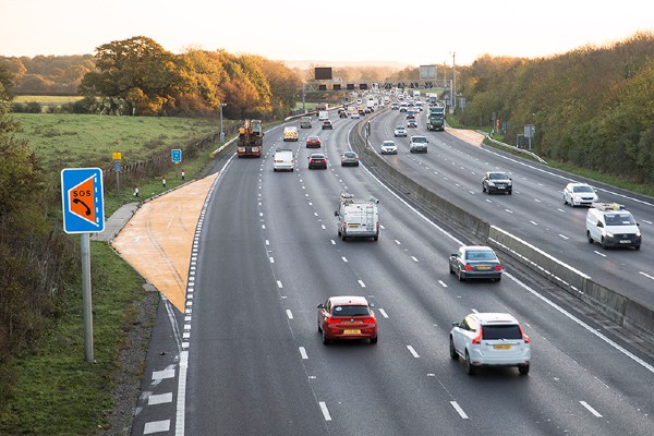 image showing a motorway without a hard shoulder with an emergency are on the left