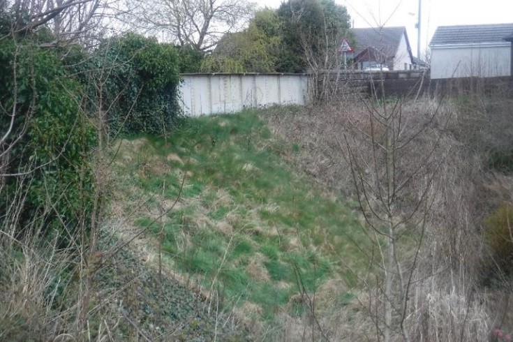 View of bridge showing embankment created from infill, 2022