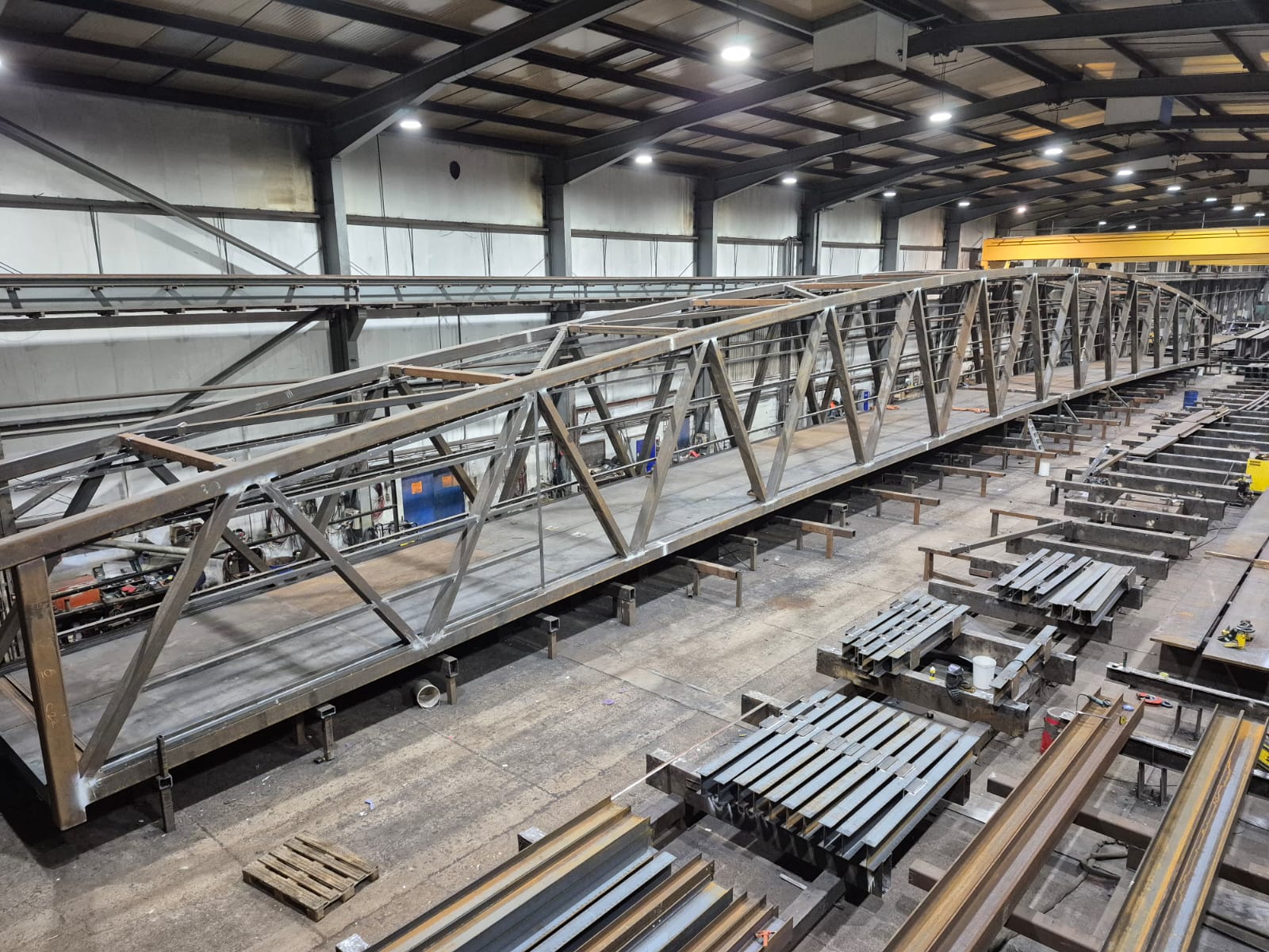 Steel footbridge in the process of being put together in storage unit