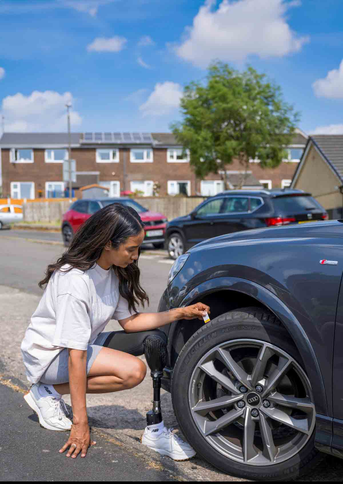 Woman checking her tyre tread