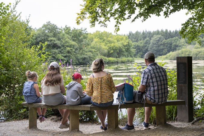 Family on bench by lake