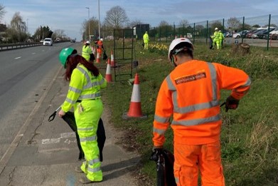 Litter picking on roadside verge