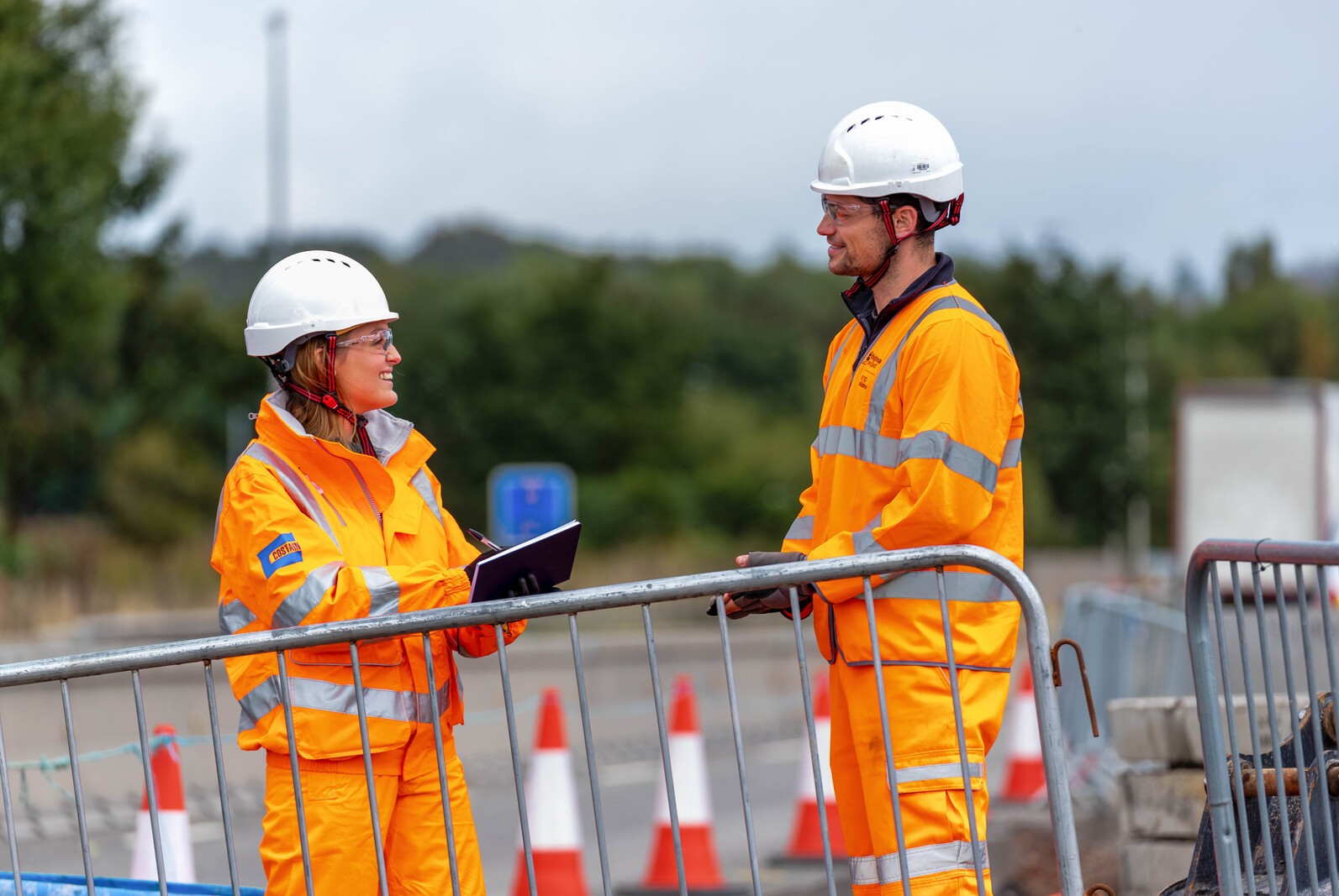 Two construction workers talking on site