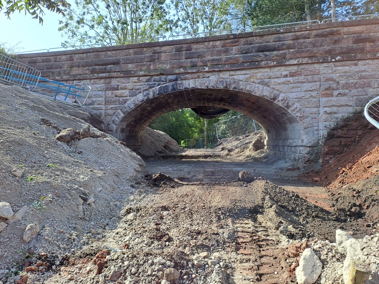 View of the arch where work has started to remove the fill material between the abutments and embankments