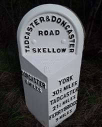 Restored way marker post - white cast iron with black letters