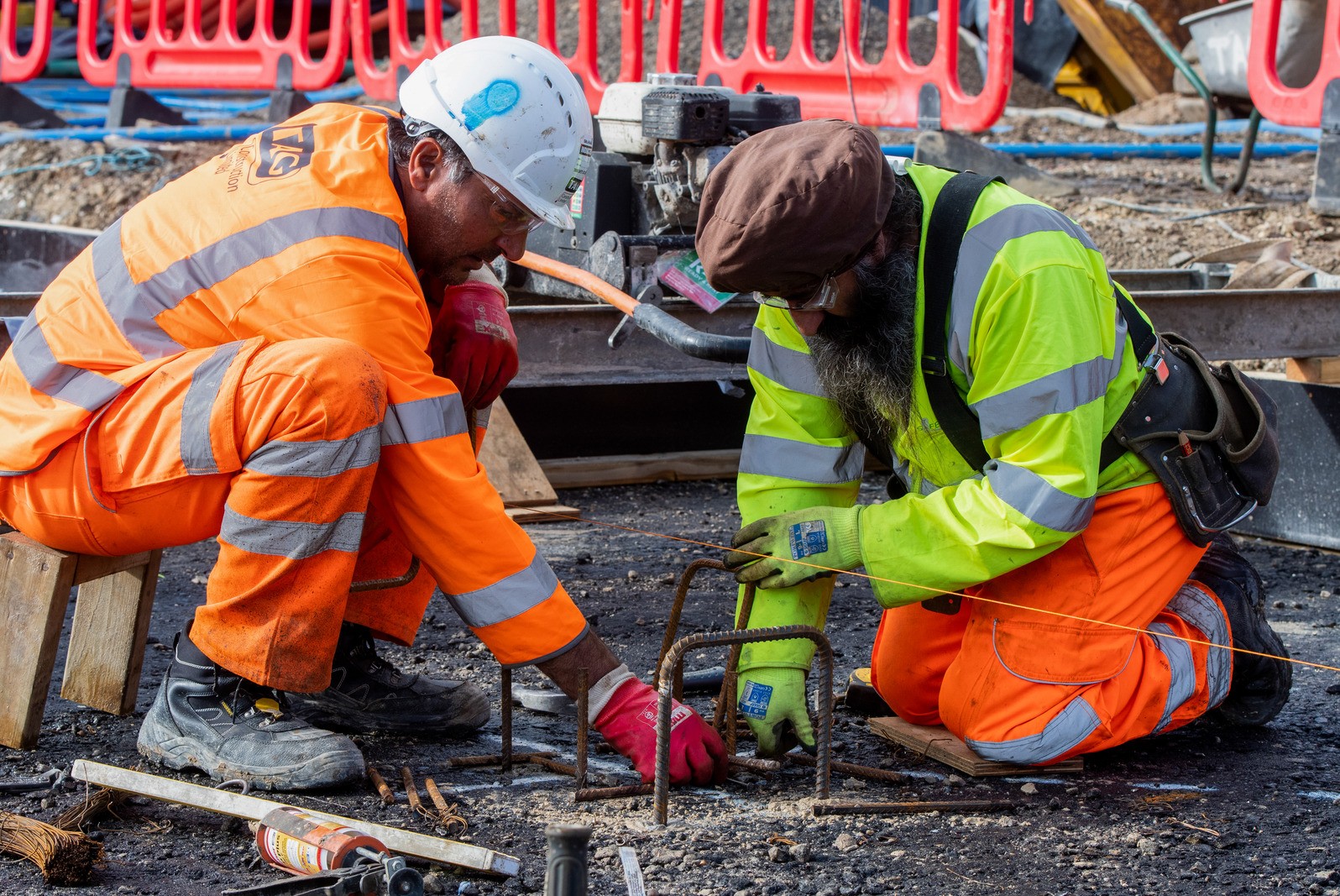 Two construction workers installing remote sensors