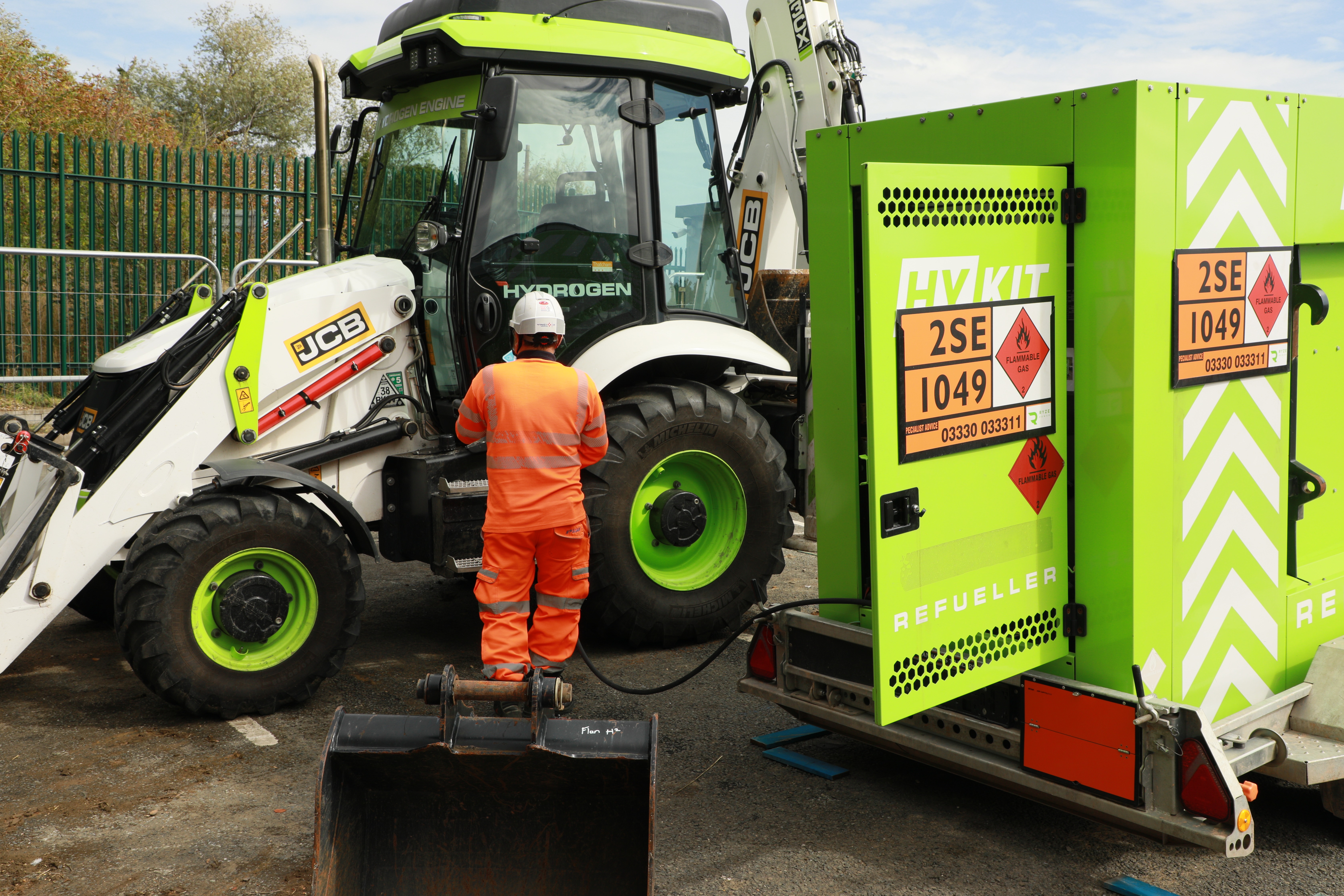 Caption: Worlds first hydrogen powered excavator developed by global manufacturer JCB being refuelled with hydrogen fuel provided by hydrogen supplier, Ryze