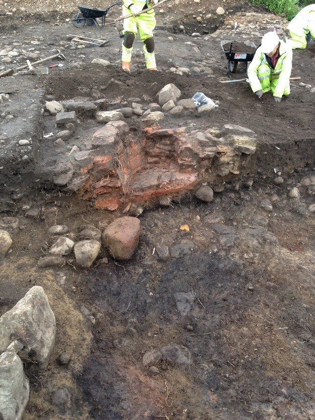 Archaeologists discovering a hearth at Brompton North