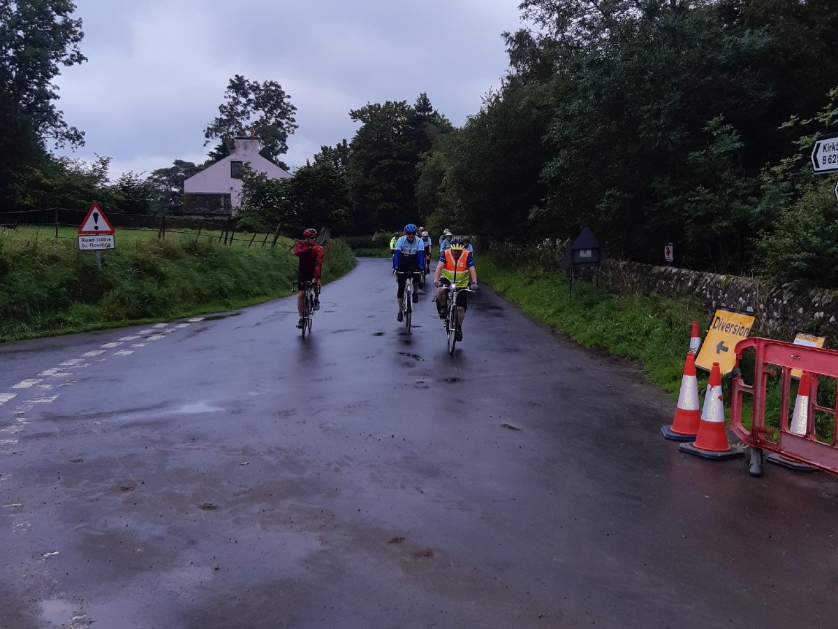 Cyclists taking part in local charity bike ride making their way over the bridge