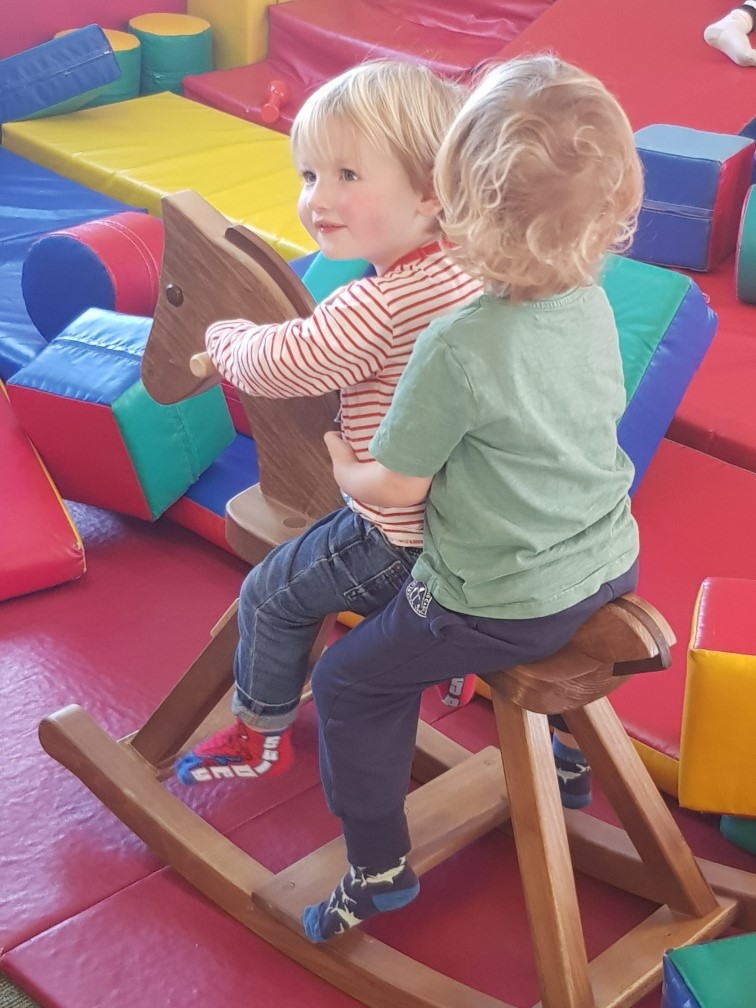 IMAGE: Children at Colchester Toy Library enjoy the new handmade wooden rocking horse