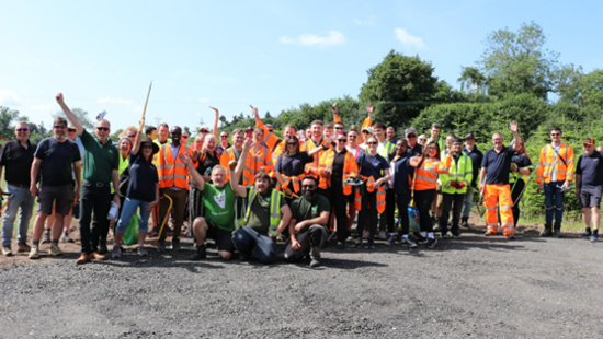 Christmas spirit arrives early for charity as army of volunteers spruce up field in the summer heat