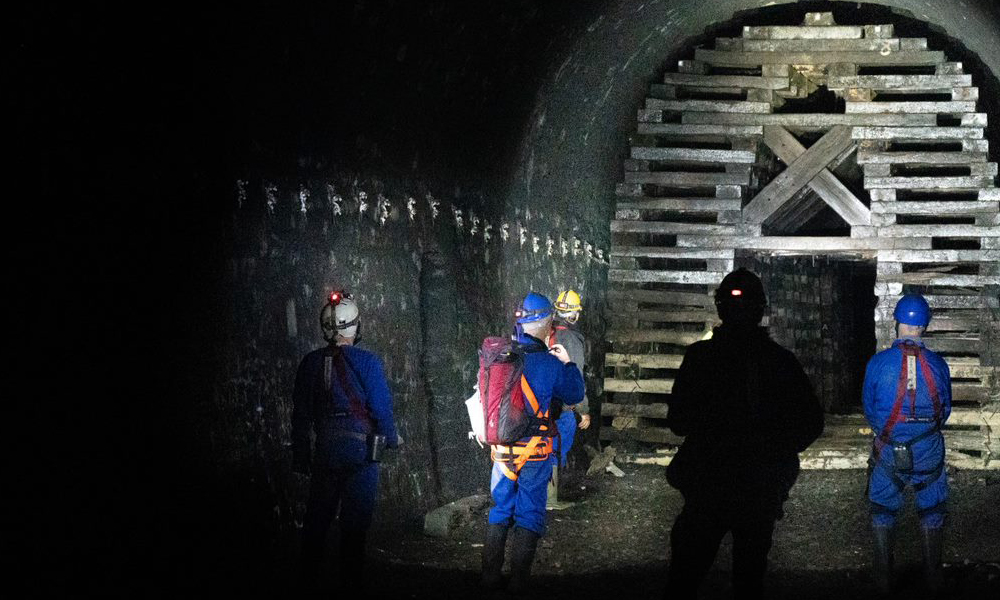 Volunteers inspect inside the tunnel