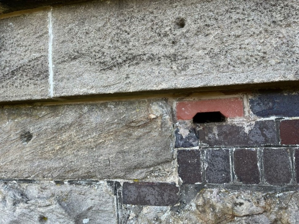 A newly-fitted red bat brick adjacent to an area of historic repairs at Westfield Viaduct in Scotland.