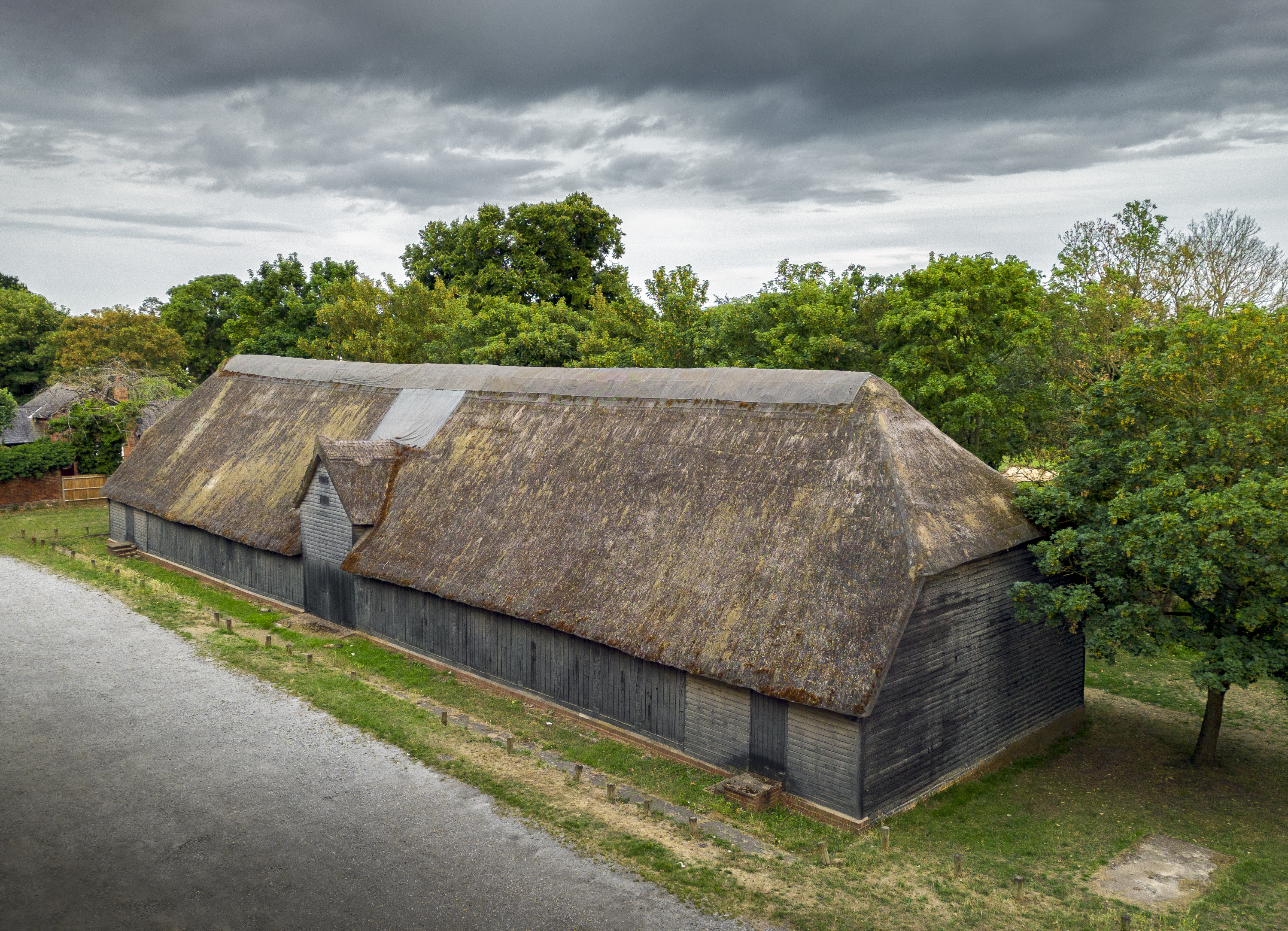 The 15th century Tithe Barn pre-restoration. Copyright Historic England Archive.