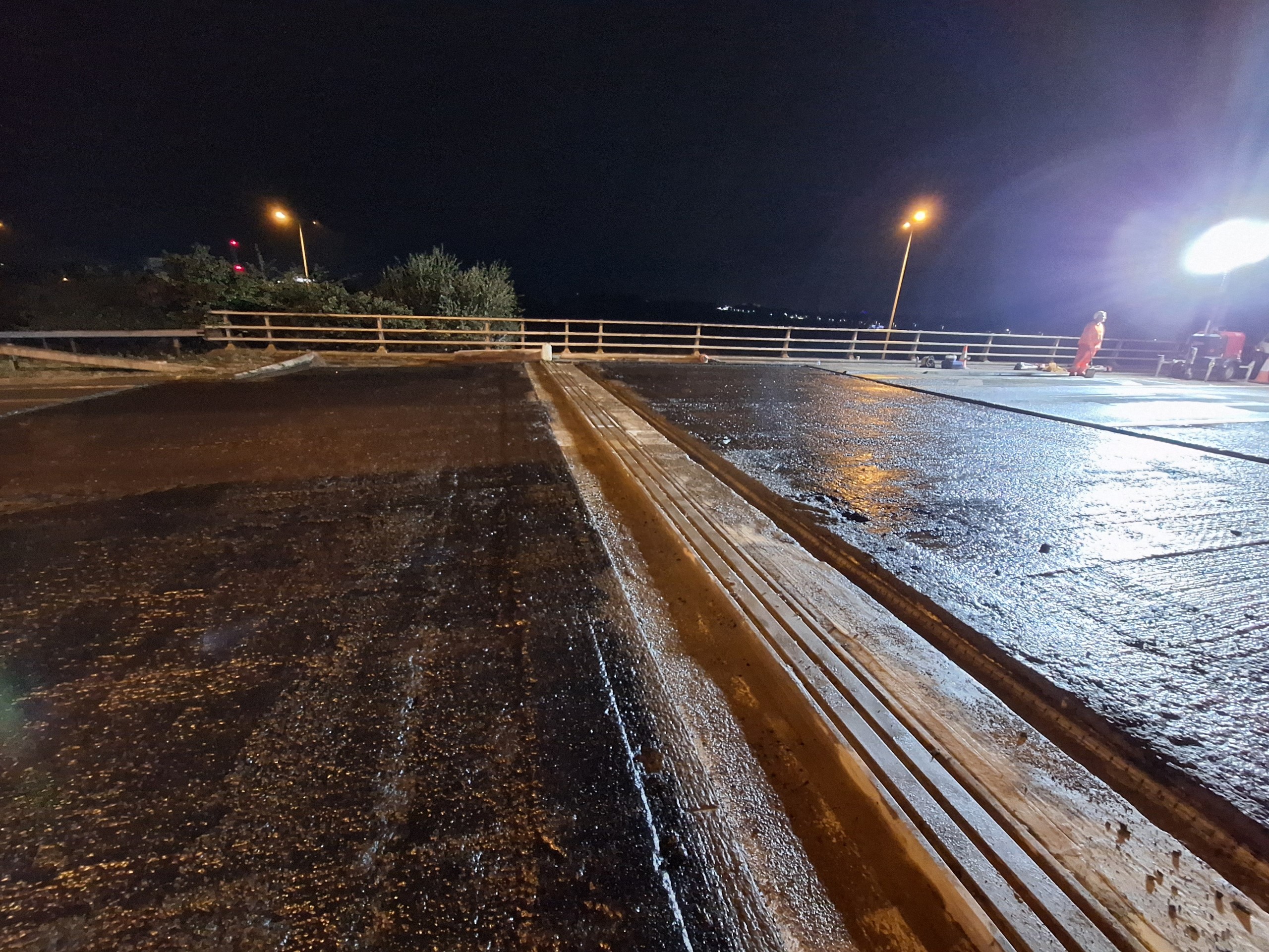 Night scene showing the new bridge expansion joint installed in the carriageway