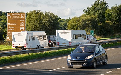 image showing cars towing caravans on a motorway 