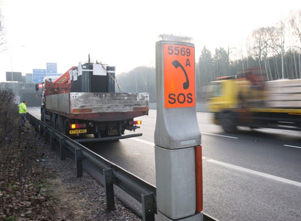 image of an SOS phone with a broken down truck onthe hard shoulder