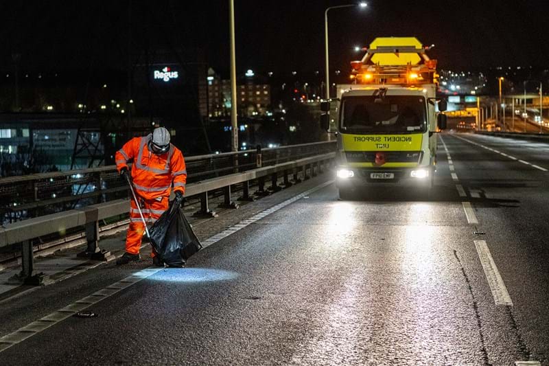 Cleaning up litter on the QEII bridge